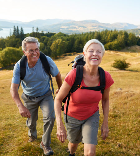 Senior couple climbing hill