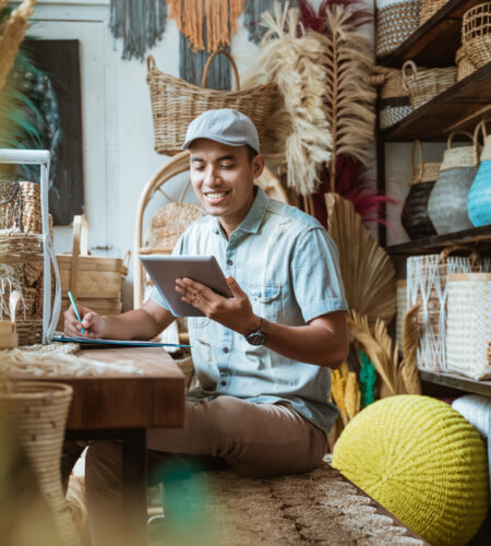 Shop owner notes with a pen