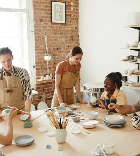 Group of people decorating ceramics