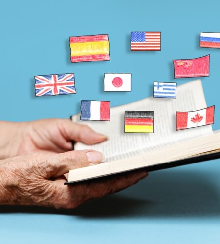 A senior woman reading a book with flags