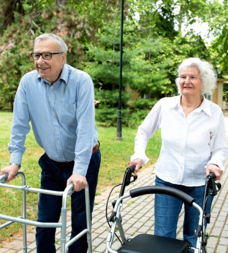 Senior couple stroll through the park