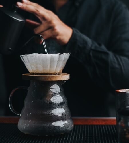 Professional barista making filtered drip coffee