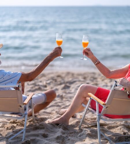 Old couple on the sand at the beach