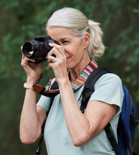 Senior Woman photography with camera in nature outdoor