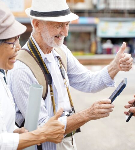 Senior tourist man poses thumbs up