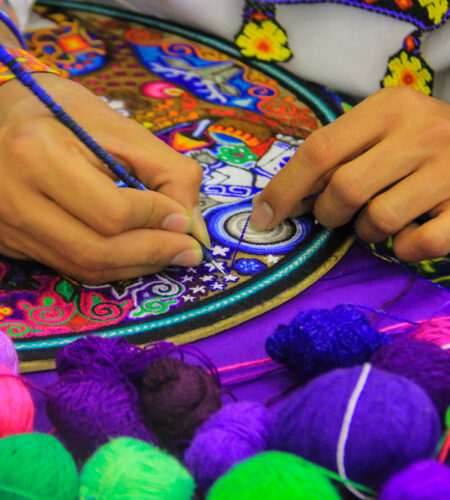 A mexican man working of his handc raft