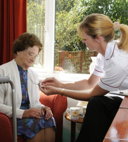 Elderly woman being given instruction