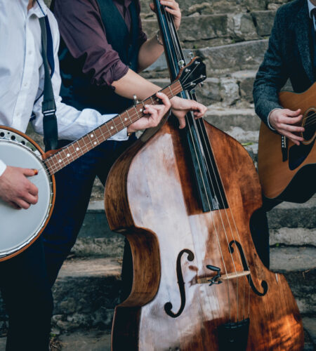 Trio of musicians with a guitar banjo and contrabass